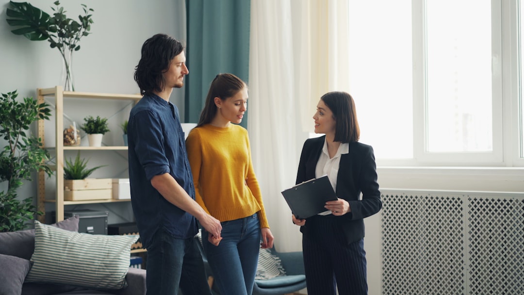 a-group-of-people-standing-in-a-living-room-jxfvsgfvnsm